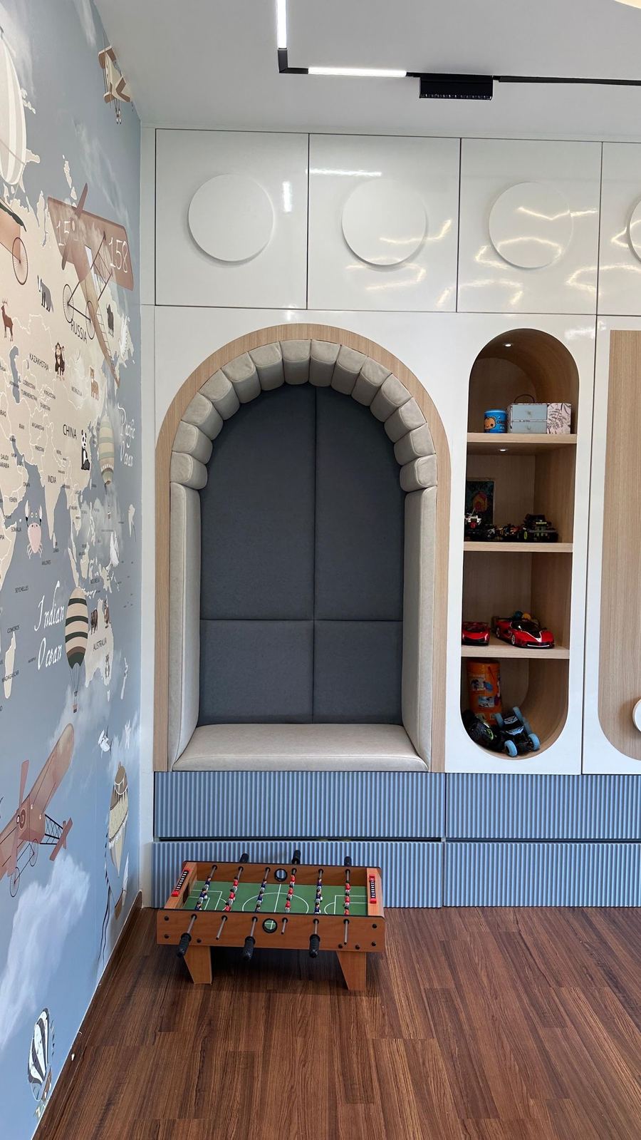 Kids room with arched reading nook and storage