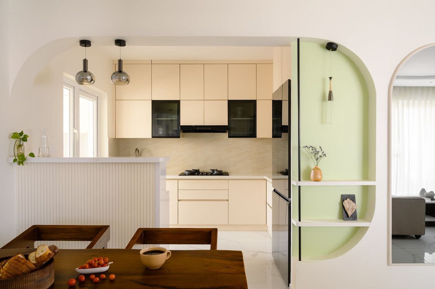 Open kitchen with pastel green arched partition