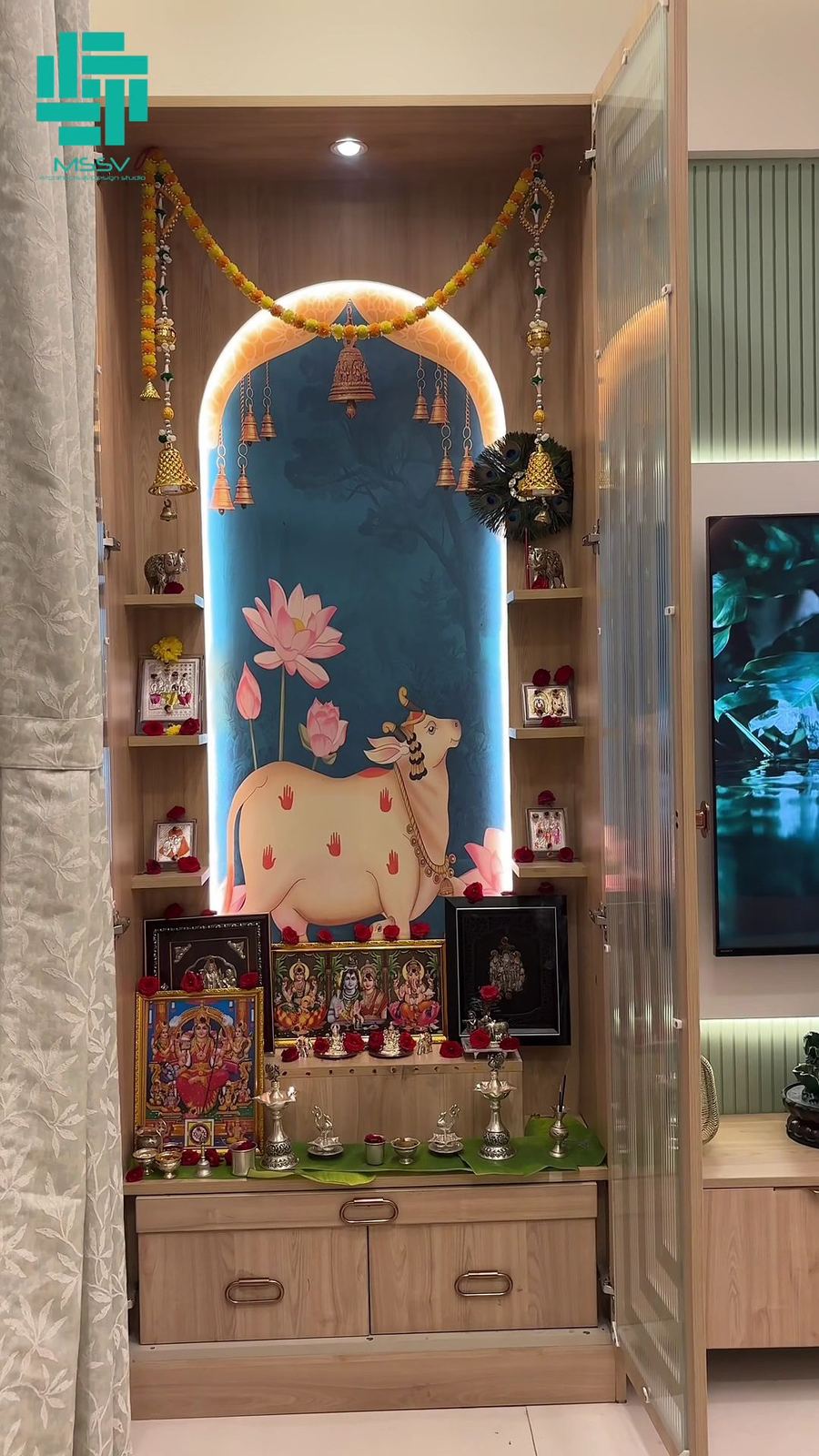 Backlit pooja unit with Pichwai cow artwork
